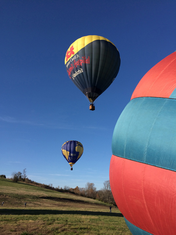 The Friendship balloon and Vanderbilt balloon take off